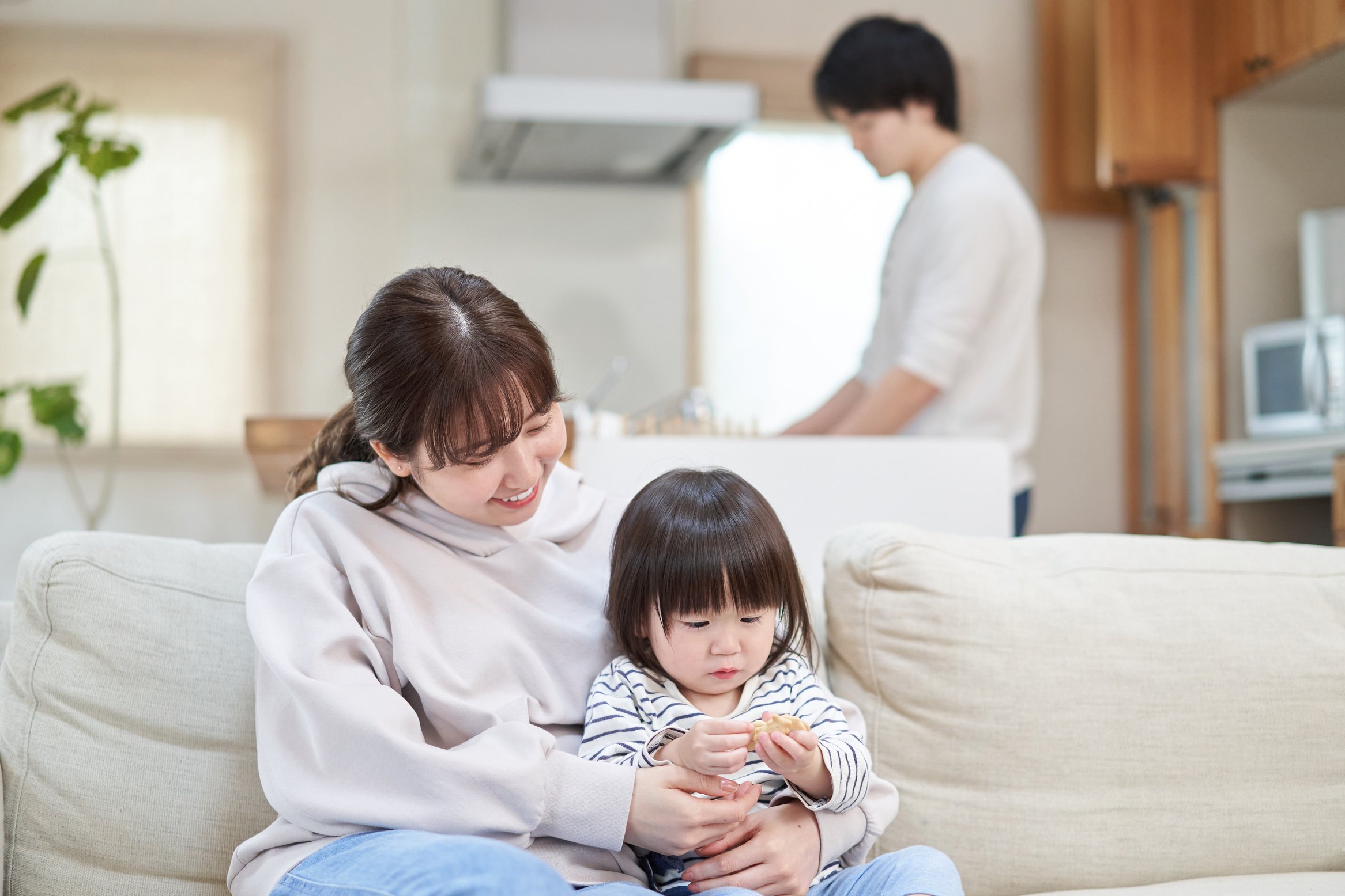 Dad doing housework and Asian mom babysitter