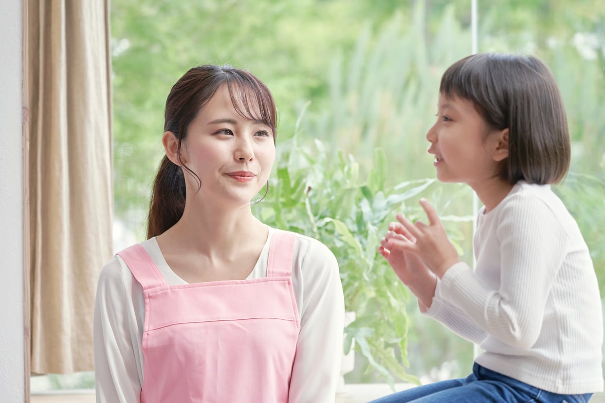 Asian nursery school teacher playing with the girl